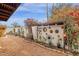 Enchanting backyard featuring desert landscaping, a decorative wall with artwork, and lush greenery, a serene outdoor oasis at 1975 E Sunburst Ln, Tempe, AZ 85284