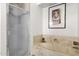 Bathroom featuring a glass door shower and soaking tub with marble and tile surround at 1975 E Sunburst Ln, Tempe, AZ 85284