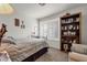 Inviting bedroom with light-filled windows, light carpet, and a decorative wood bookcase at 1975 E Sunburst Ln, Tempe, AZ 85284