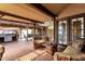 Inviting covered patio with terracotta tile, wood beams, and comfortable seating, perfect for outdoor relaxation and entertainment at 1975 E Sunburst Ln, Tempe, AZ 85284