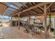 Covered patio featuring an outdoor kitchen, dining area, and stone flooring, ideal for entertaining and relaxation at 1975 E Sunburst Ln, Tempe, AZ 85284