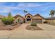 Charming single-story home featuring desert landscaping, a two-car garage, and a welcoming front entry at 1975 E Sunburst Ln, Tempe, AZ 85284