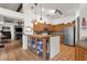 Open kitchen featuring a breakfast bar with glass display cabinets and stainless steel appliances at 1975 E Sunburst Ln, Tempe, AZ 85284