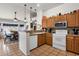 Well-lit kitchen featuring tile floors, stainless appliances, and a functional layout with views to dining area at 1975 E Sunburst Ln, Tempe, AZ 85284