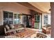 Covered patio featuring terracotta tiles, a retro coca-cola fridge, and comfortable wicker furniture at 1975 E Sunburst Ln, Tempe, AZ 85284