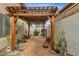 Secluded side yard with desert landscaping, a pergola, and stone pathway, providing a peaceful outdoor retreat at 1975 E Sunburst Ln, Tempe, AZ 85284