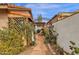 Landscaped side yard featuring desert plants, a stone path, and a decorative archway, enhancing the property's curb appeal at 1975 E Sunburst Ln, Tempe, AZ 85284