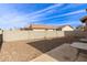 Backyard has a gravel landscape, block fence and concrete patio at 20212 N Valencia Dr, Maricopa, AZ 85138