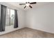 Bedroom with neutral carpet, lighted ceiling fan and window with privacy drapes at 20212 N Valencia Dr, Maricopa, AZ 85138