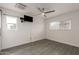 Bright bedroom features gray wood-look floors, a ceiling fan and ample natural light at 20212 N Valencia Dr, Maricopa, AZ 85138