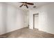 Bedroom with neutral carpet, lighted ceiling fan and closet with sliding doors at 20212 N Valencia Dr, Maricopa, AZ 85138