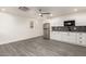 Well lit kitchen features stainless steel appliances, gray backsplash and white cabinetry at 20212 N Valencia Dr, Maricopa, AZ 85138