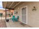 Covered patio features charming decor and seating area at 20212 N Valencia Dr, Maricopa, AZ 85138