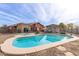 Aerial view of private backyard pool and covered patio perfect for entertaining guests at 20212 N Valencia Dr, Maricopa, AZ 85138