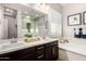 Well-lit bathroom featuring double sinks, a soaking tub, and a separate glass-enclosed shower at 20524 W Nelson Pl, Buckeye, AZ 85396