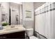 Neat bathroom featuring a dark vanity with a white countertop, toilet, and shower curtain at 20524 W Nelson Pl, Buckeye, AZ 85396