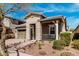 Inviting home featuring a stone facade, covered front porch, and a two-car garage at 20524 W Nelson Pl, Buckeye, AZ 85396