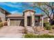 Charming single-story home featuring a stone facade, brick driveway, and well-maintained landscaping at 20524 W Nelson Pl, Buckeye, AZ 85396