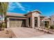 Charming home with a stone facade, a well-manicured lawn, and a two-car garage at 20524 W Nelson Pl, Buckeye, AZ 85396