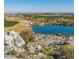 Scenic golf course with a serene pond, boulders, desert plants, and views at 20524 W Nelson Pl, Buckeye, AZ 85396