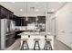 Well-lit kitchen featuring a large island with seating, stainless steel appliances, and sleek countertops at 20524 W Nelson Pl, Buckeye, AZ 85396