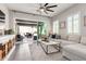 Open-concept living room with a neutral color palette, plush seating, and sliding glass doors to the patio at 20524 W Nelson Pl, Buckeye, AZ 85396