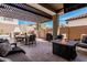 Enjoyable outdoor living space including a covered patio with fire table, dining area, and a built-in grill at 20524 W Nelson Pl, Buckeye, AZ 85396