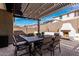 Outdoor patio with a fireplace, comfortable seating, and a pergola with string lights at 20524 W Nelson Pl, Buckeye, AZ 85396