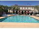 Resort-style pool with splash pad, umbrellas, and lounge chairs for relaxing under the sun at 20524 W Nelson Pl, Buckeye, AZ 85396