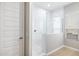 Bathroom showcasing the walk-in shower with clear glass doors and white tiled walls, complemented by neutral-toned walls at 21323 N 61St St, Phoenix, AZ 85054