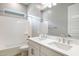 Bright bathroom with double vanity, quartz countertop, large mirror, and tub with shower at 21323 N 61St St, Phoenix, AZ 85054