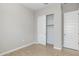 Neutral bedroom featuring wood-look tile flooring, closet with sliding doors and a doorway at 21323 N 61St St, Phoenix, AZ 85054