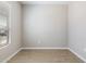 Bright bedroom with a window, neutral walls, and tile flooring, creating a cozy and inviting atmosphere at 21323 N 61St St, Phoenix, AZ 85054