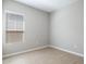 Bright bedroom features wood-look tile flooring and a window with white blinds at 21323 N 61St St, Phoenix, AZ 85054