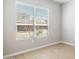 Neutral-toned bedroom with a large window that offers a view of the outside, flooding the space with natural light at 21323 N 61St St, Phoenix, AZ 85054