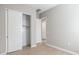 Neutral bedroom featuring wood-look tile flooring, closet with sliding doors and a doorway at 21323 N 61St St, Phoenix, AZ 85054