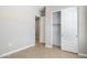 Bedroom featuring a sliding door closet and doorways, painted in neutral colors, with tile flooring at 21323 N 61St St, Phoenix, AZ 85054