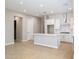 Open-concept kitchen featuring a stylish island, white cabinets, subway tile backsplash, and stainless steel appliances at 21323 N 61St St, Phoenix, AZ 85054