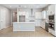 Bright kitchen featuring white cabinets, subway tile backsplash, stainless steel appliances, and a spacious island at 21323 N 61St St, Phoenix, AZ 85054