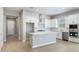 Elegant kitchen showcasing a large island, white cabinets, subway tile backsplash, and stainless steel appliances at 21323 N 61St St, Phoenix, AZ 85054