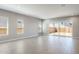 Spacious living room with tile flooring and sliding glass doors leading to a fenced backyard at 21323 N 61St St, Phoenix, AZ 85054