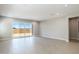 Open-concept living space with tile floors, recessed lighting, and sliding glass doors overlooking the backyard at 21323 N 61St St, Phoenix, AZ 85054