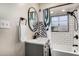 Bathroom featuring a shower-tub combo, a black framed oval mirror, and modern fixtures at 2201 N 17Th Ave, Phoenix, AZ 85007