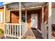 Welcoming front porch with a cozy seating area, brick accents, and a view of the charming white front door at 2201 N 17Th Ave, Phoenix, AZ 85007