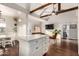 Open concept kitchen and living space with a marble island and rustic wood beams at 2201 N 17Th Ave, Phoenix, AZ 85007