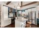 Modern kitchen with marble countertop island, stainless steel appliances, and unique blue backsplash at 2201 N 17Th Ave, Phoenix, AZ 85007