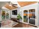 Open living room featuring a wood ceiling, access to backyard, and a flat-screen TV at 2201 N 17Th Ave, Phoenix, AZ 85007