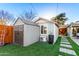 Backyard view of a convenient outbuilding, small air conditioner, and storage shed at 2201 N 17Th Ave, Phoenix, AZ 85007