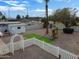 Aerial view of the backyard featuring desert landscaping, a white fence, and a playset at 2205 W Cambridge Ave, Phoenix, AZ 85009