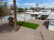 Aerial view of the backyard featuring desert landscaping, turf rectangle, playset, and a dog in the shade at 2205 W Cambridge Ave, Phoenix, AZ 85009